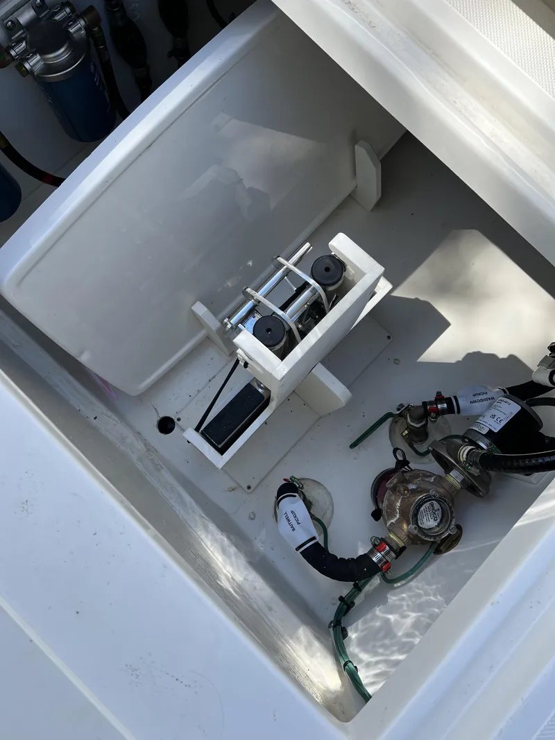 Slide: The Image of 2023 Pursuit S 288 boat compartment with mechanical components and wiring. - 28