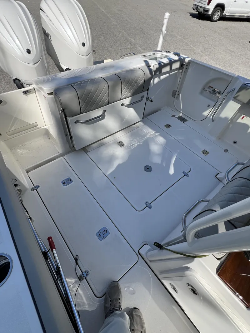 Slide: The Image of 2023 Pursuit S 288 boat deck with seating and dual engines. - 29