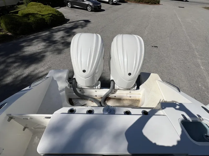 Slide: The Image of 2023 Pursuit S 288 boat with dual outboard engines in a parking lot. - 30