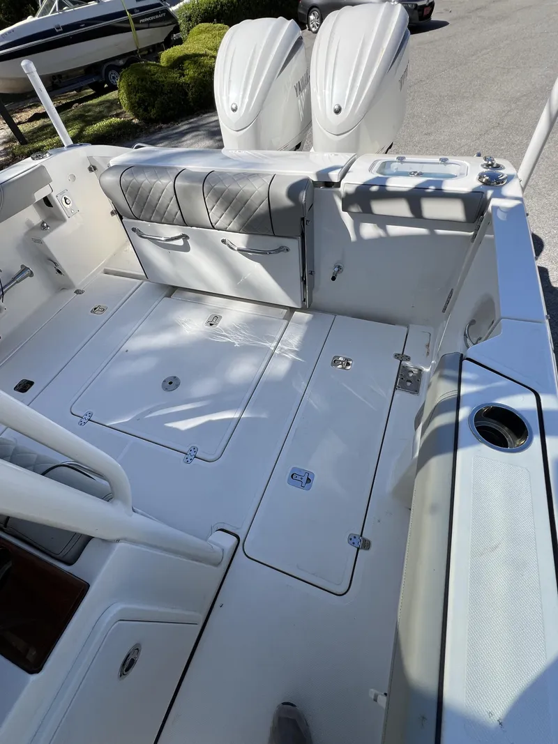 Slide: The Image of 2023 Pursuit S 288 boat deck with dual Yamaha engines, spacious seating, and storage compartments. - 31
