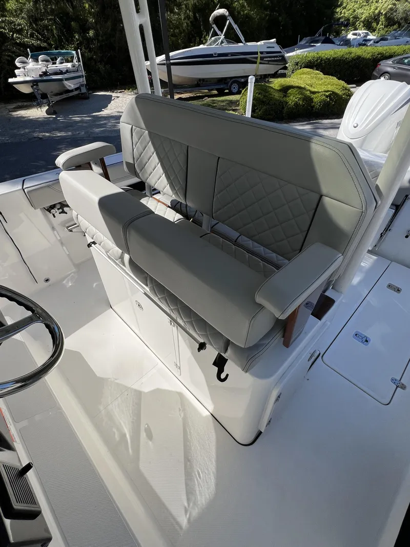 Slide: The Image of 2023 Pursuit S 288 boat interior with cushioned seating and steering wheel. - 33