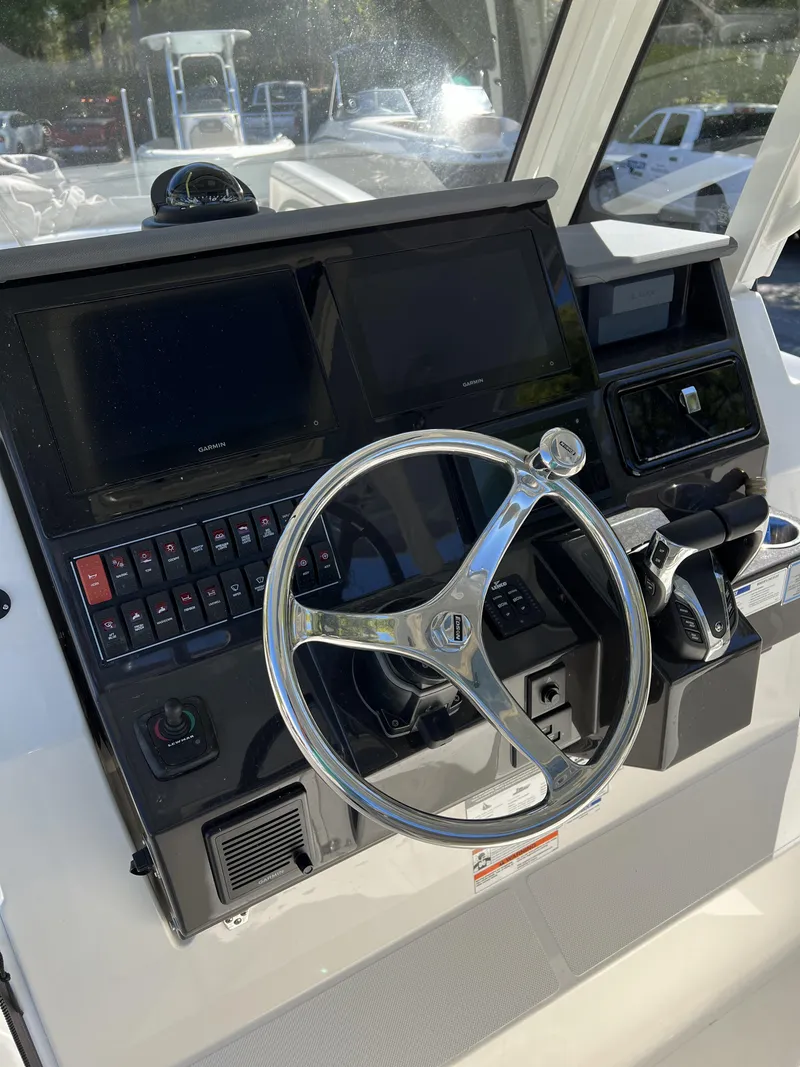 Slide: The Image of 2023 Pursuit S 288 helm with steering wheel and control panel. - 34