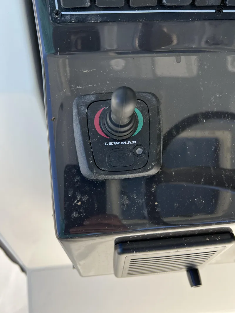 Slide: The Image of Lewmar joystick control on 2023 Pursuit S 288 boat dashboard. - 35