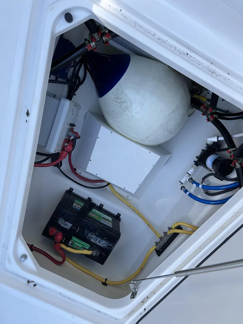 Slide: The Image of 2023 Pursuit S 288 boat compartment with battery and wiring. - 37