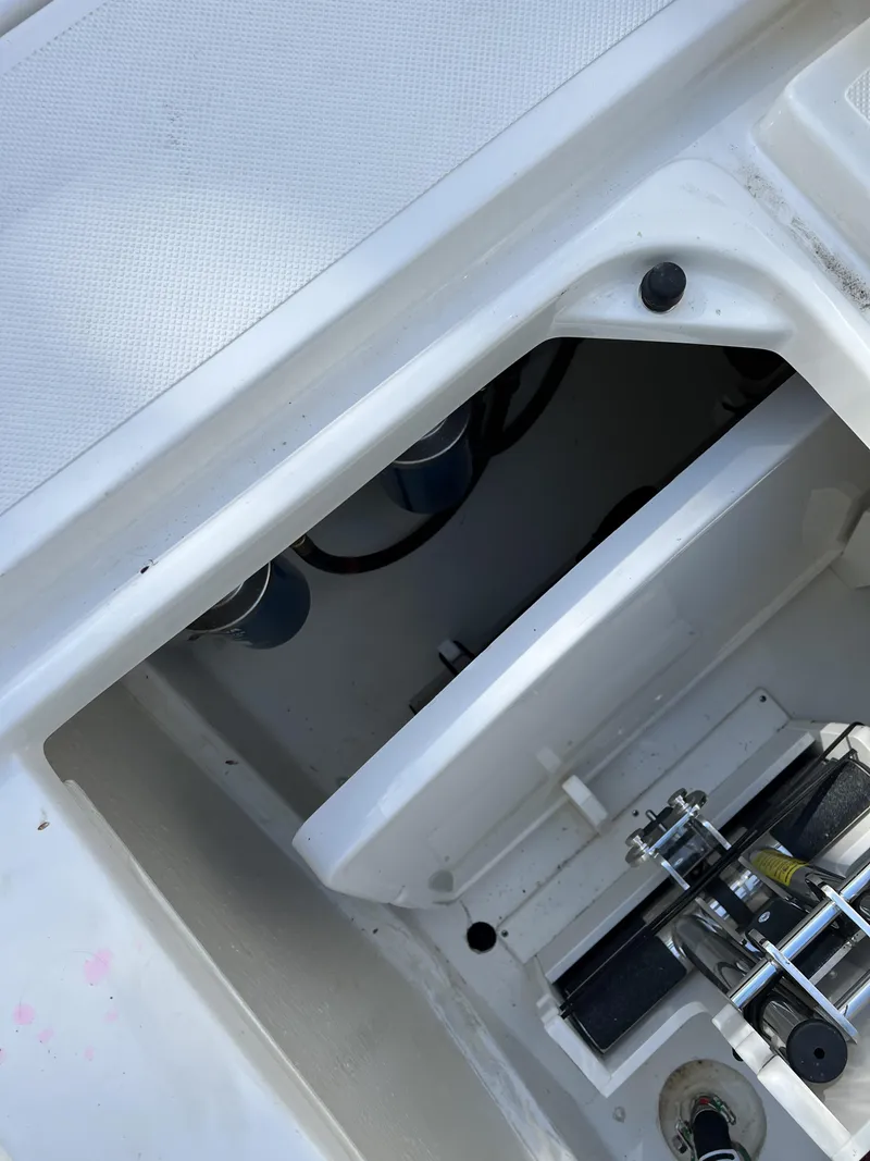 Slide: The Image of 2023 Pursuit S 288 boat interior compartment with visible mechanical components. - 5