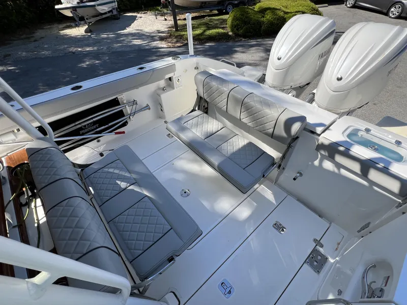 Slide: The Image of 2023 Pursuit S 288 boat interior with dual engines and cushioned seating. - 6