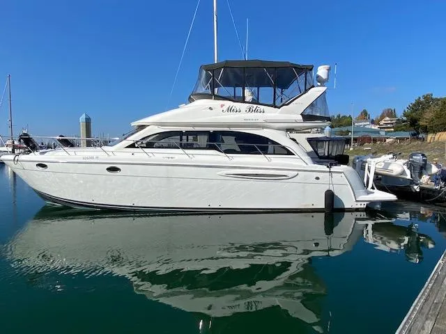 The Image of 2003 Meridian 411 yacht docked in calm waters under a clear blue sky. - 0