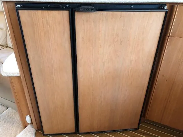 Slide: The Image of Wood-paneled refrigerator in 2003 Meridian 411 yacht interior. - 14