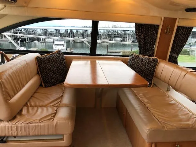 Slide: The Image of Luxurious 2003 Meridian 411 yacht interior with leather seating and wooden table. - 17
