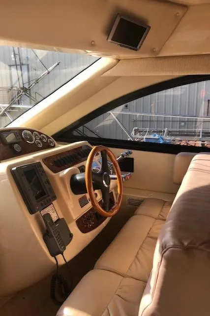 Slide: The Image of Interior of a 2003 Meridian 411 yacht with leather seating and wooden steering wheel. - 19