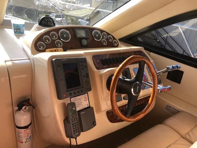 Slide: The Image of 2003 Meridian 411 yacht helm with steering wheel, gauges, and navigation equipment. - 20