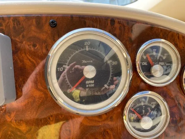 Slide: The Image of Dashboard gauges of a 2003 Meridian 411 boat, showing RPM, oil, and temperature. - 24