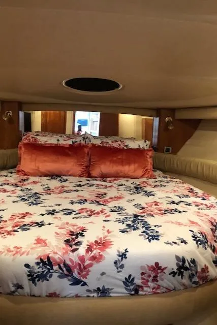 Slide: The Image of Luxurious bedroom interior of 2003 Meridian 411 yacht with floral bedding and plush pillows. - 27