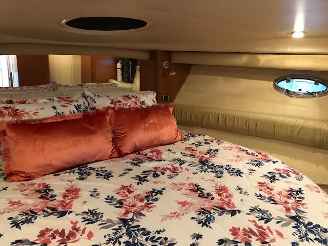 Slide: The Image of Luxurious 2003 Meridian 411 yacht bedroom with floral bedding and plush pillows. - 28