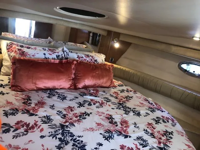 Slide: The Image of Luxurious 2003 Meridian 411 yacht bedroom with floral bedding and plush pillows. - 29