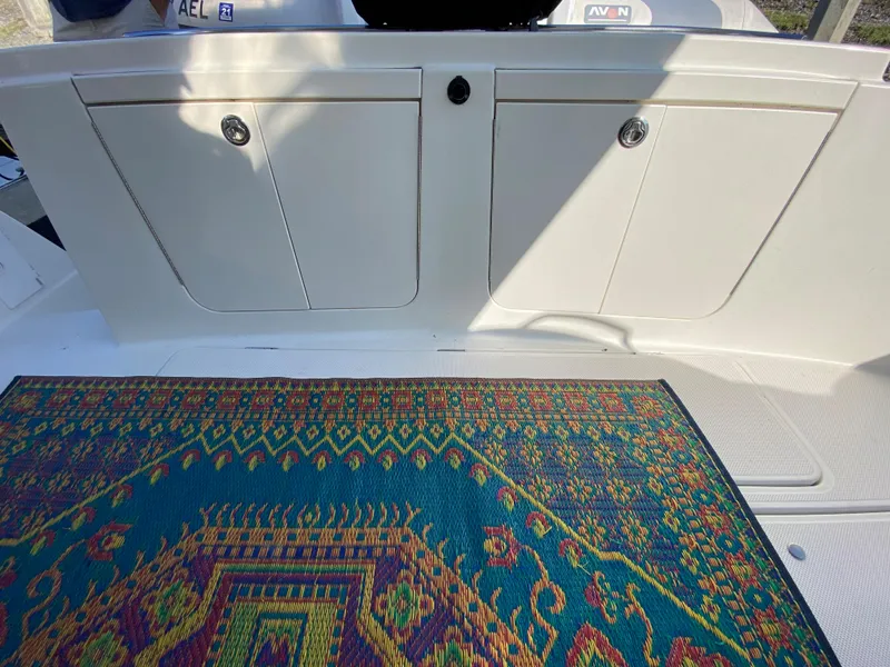 Slide: The Image of Colorful rug on a 2003 Meridian 411 boat deck with storage compartments. - 3