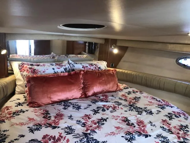 Slide: The Image of Luxurious 2003 Meridian 411 yacht bedroom with floral bedding and plush pillows. - 30
