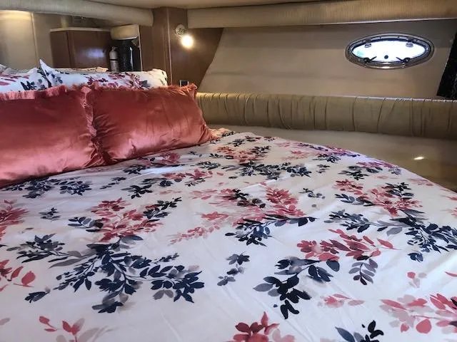 Slide: The Image of Luxurious bedroom interior of 2003 Meridian 411 yacht with floral bedding and plush pillows. - 31