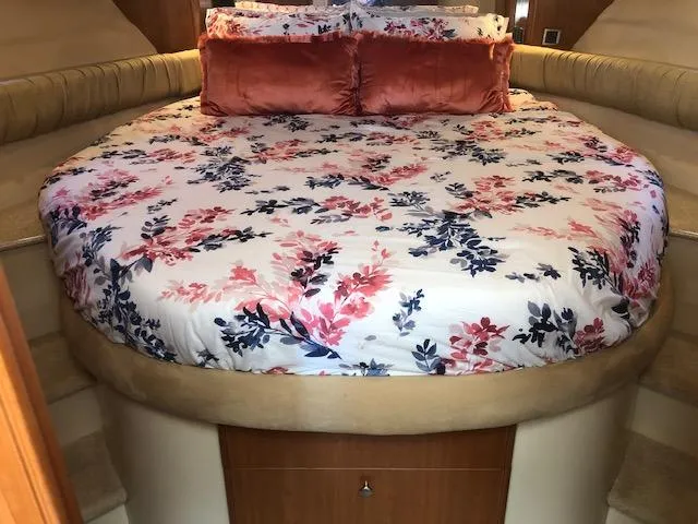 Slide: The Image of Luxurious 2003 Meridian 411 yacht bedroom with floral bedding and plush pillows. - 32