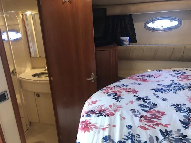 Slide: The Image of Cozy cabin interior of 2003 Meridian 411 yacht with floral bedding and ensuite bathroom. - 35