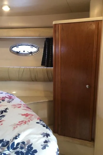 Slide: The Image of Interior of 2003 Meridian 411 yacht with floral bedding and wooden cabinet. - 36