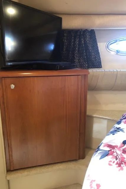 Slide: The Image of Interior of 2003 Meridian 411 yacht with TV and wooden cabinet. - 37