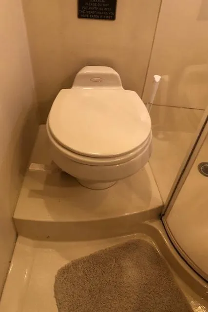 Slide: The Image of 2003 Meridian 411 yacht bathroom with toilet and shower area. - 41