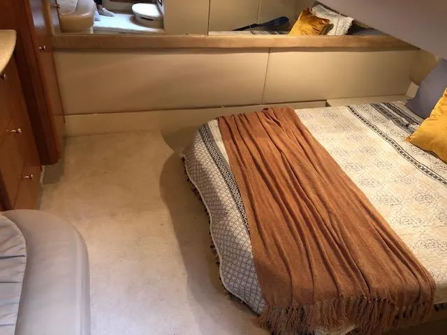 Slide: The Image of Cozy bedroom interior of 2003 Meridian 411 yacht with warm decor and soft lighting. - 44