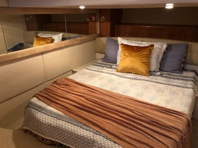 Slide: The Image of Luxurious bedroom interior of 2003 Meridian 411 yacht with cozy bedding and ambient lighting. - 45