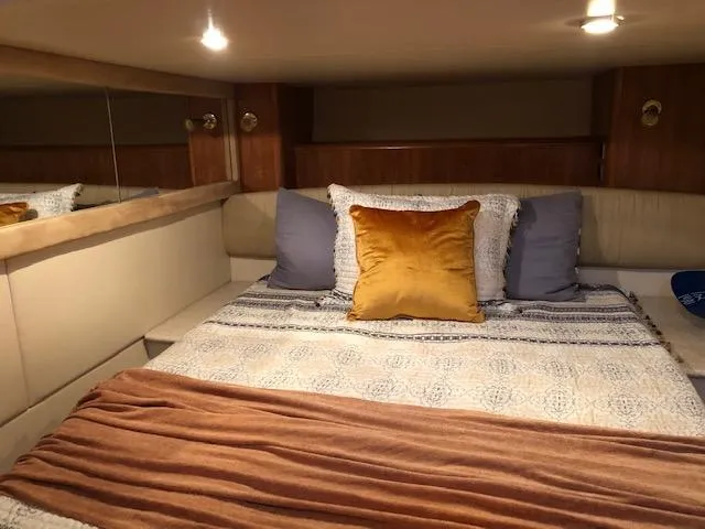 Slide: The Image of Cozy bedroom in 2003 Meridian 411 yacht with plush pillows and warm lighting. - 46
