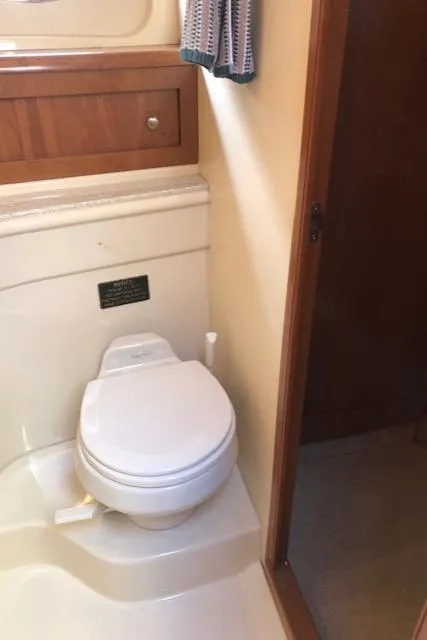 Slide: The Image of 2003 Meridian 411 yacht bathroom with toilet and wooden cabinetry. - 49