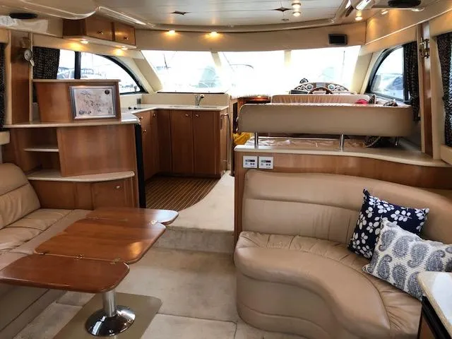 Slide: The Image of Luxurious interior of a 2003 Meridian 411 yacht with elegant seating and wooden finishes. - 6