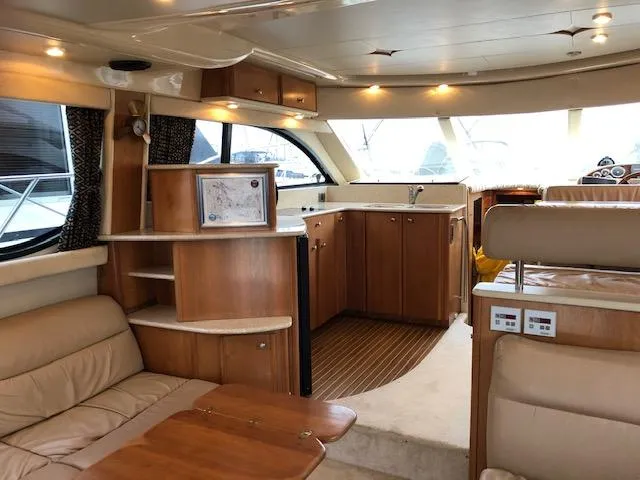Slide: The Image of Luxurious interior of a 2003 Meridian 411 yacht with wood finishes and leather seating. - 8