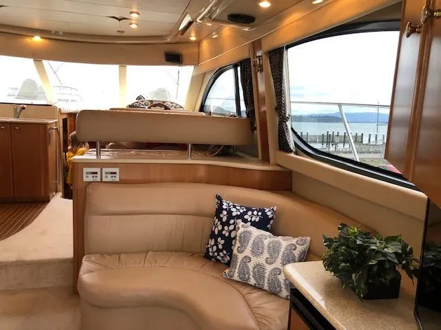 Slide: The Image of Luxurious interior of a 2003 Meridian 411 yacht with plush seating and elegant decor. - 9