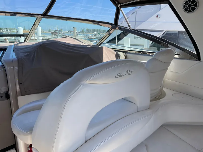 Slide: The Image of Interior of 2001 Sea Ray 380 Sundancer yacht with white seating and marina view. - 12