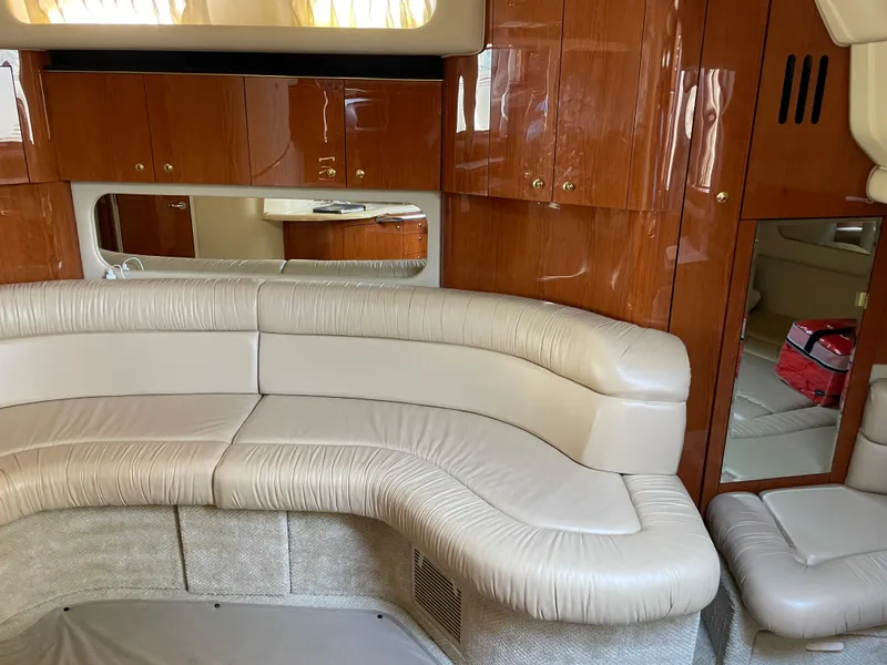 Slide: The Image of Luxurious interior of 2001 Sea Ray 380 Sundancer with leather seating and wooden cabinetry. - 16