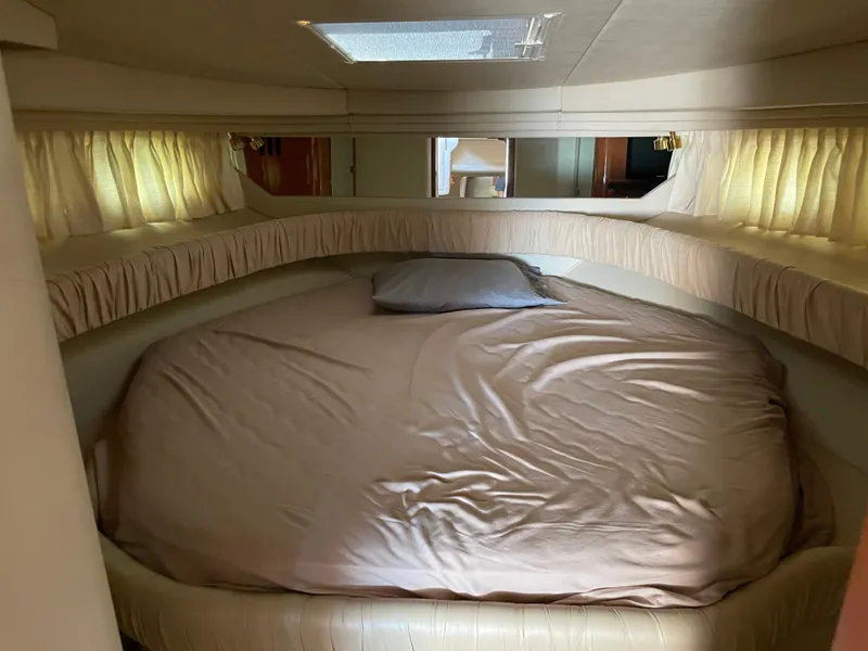 Slide: The Image of Cozy bedroom interior of 2001 Sea Ray 380 Sundancer yacht with soft lighting. - 18