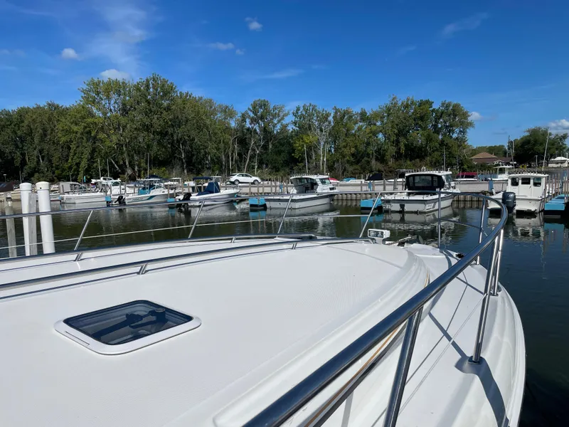 Slide: The Image of 2001 Sea Ray 380 Sundancer docked at marina under clear blue sky. - 4