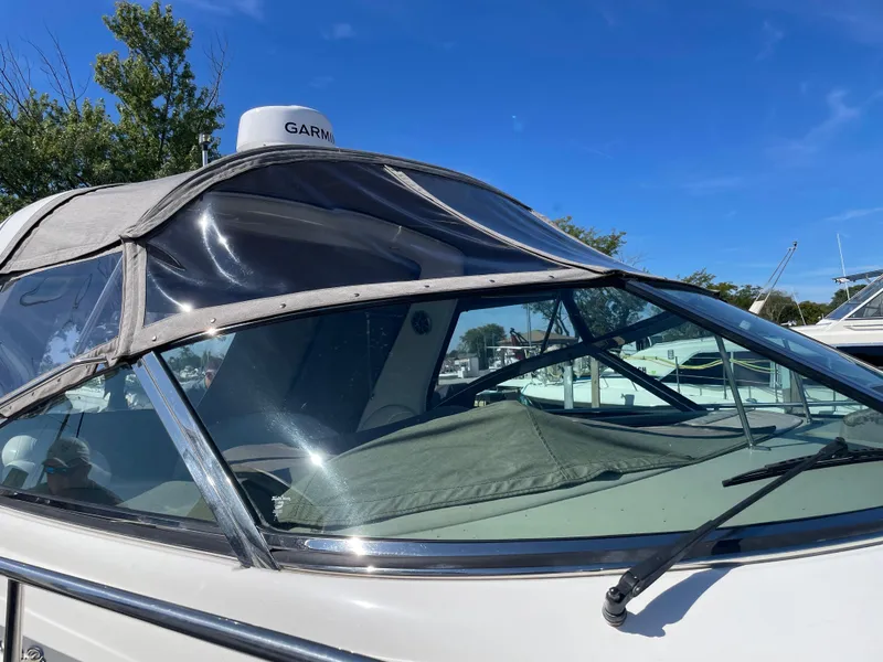 Slide: The Image of 2001 Sea Ray 380 Sundancer boat with Garmin radar, docked under clear blue sky. - 5