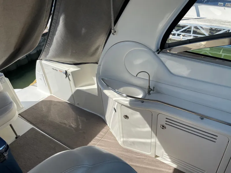 Slide: The Image of Interior of 2001 Sea Ray 380 Sundancer yacht with sink and seating area. - 8