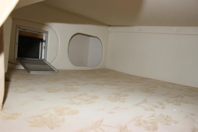 Slide: The Image of Interior cabin view of a 2006 Rinker 270 Express Cruiser, featuring a vent and floral-patterned surface. - 38