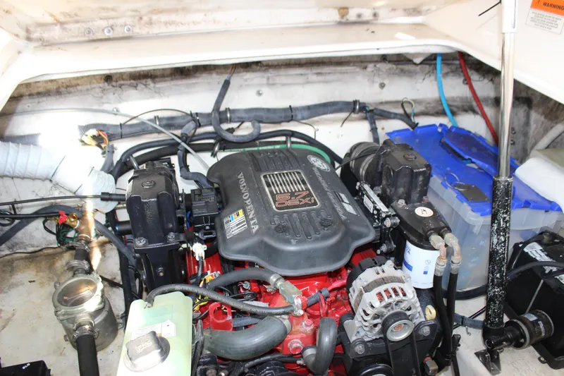 Slide: The Image of Engine compartment of 2006 Rinker 270 Express Cruiser with visible components and wiring. - 49