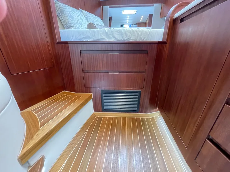 Slide: The Image of Luxurious interior of 2021 Jupiter 41 SB yacht with wooden flooring and cozy bedding. - 14