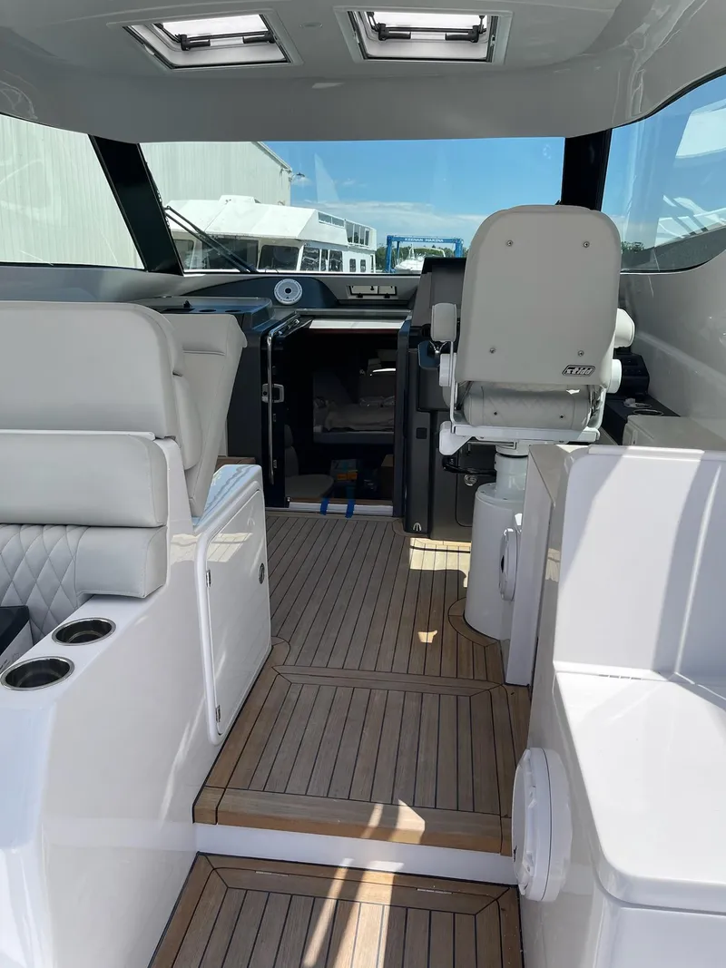 Slide: The Image of Interior of 2021 Jupiter 41 SB boat with modern seating and wooden flooring. - 5