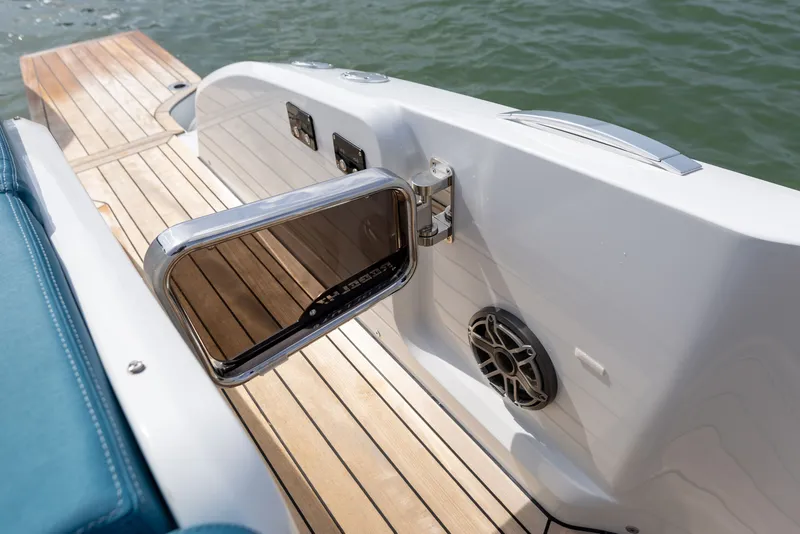 Slide: The Image of The image shows the deck of a 2025 SACS Rebel 47 with sleek wood flooring and a speaker. - 38