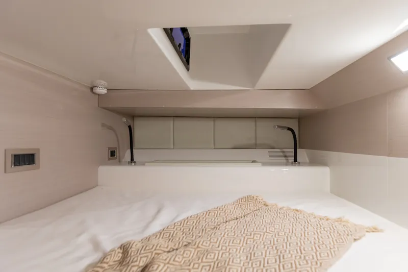 Slide: The Image of Interior of the 2025 SACS Rebel 47 featuring a cozy bed and modern design. - 49
