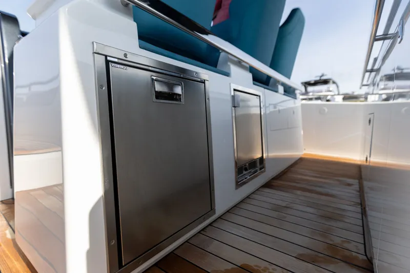 Slide: The Image of The 2025 SACS Rebel 47 features a modern onboard kitchen with stainless steel appliances and wooden flooring. - 35