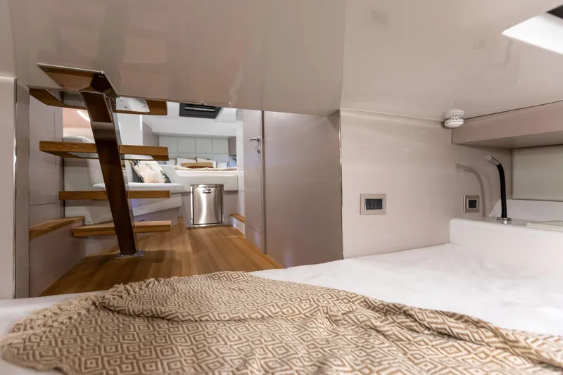 Slide: The Image of Interior of the 2025 SACS Rebel 47 with modern wood flooring and sleek staircase. - 48