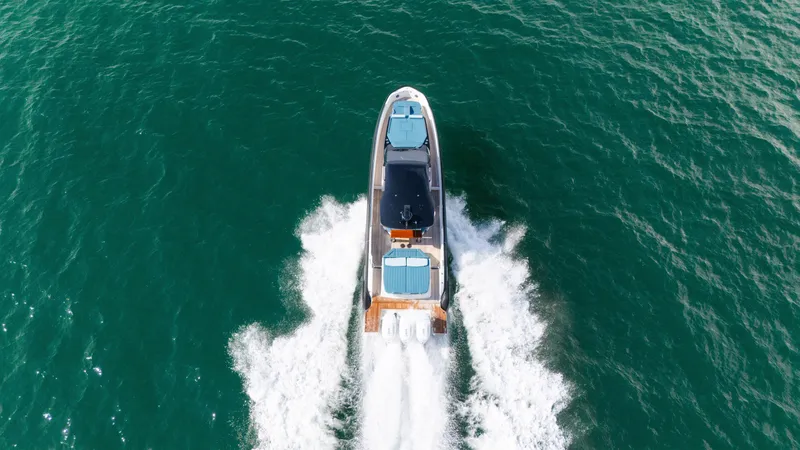 Slide: The Image of Aerial view of a SACS Rebel 47 boat speeding across the sea. - 18