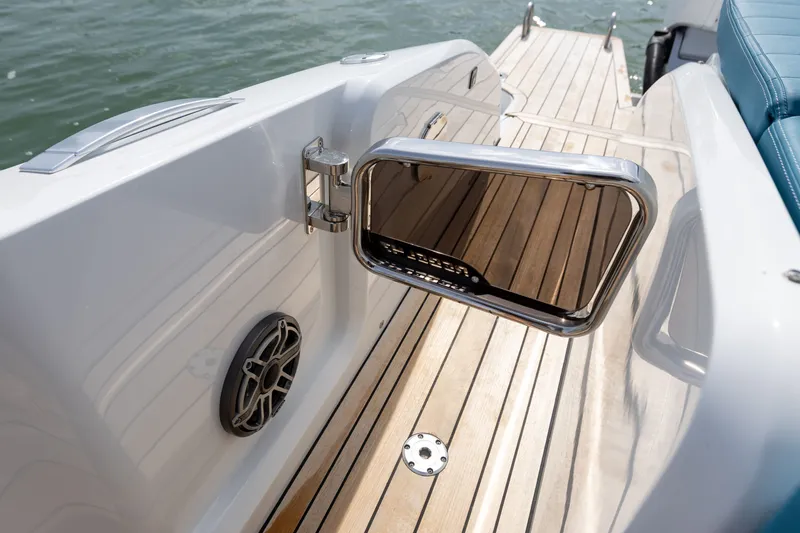 Slide: The Image of The 2025 SACS Rebel 47 features a sleek teak deck and modern stainless steel accents. - 39